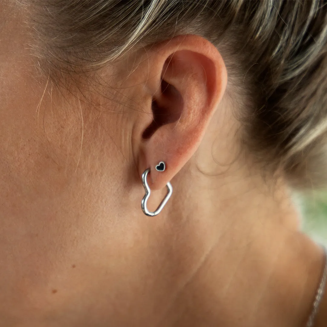 Silver coloured hoop earrings with a heart shape